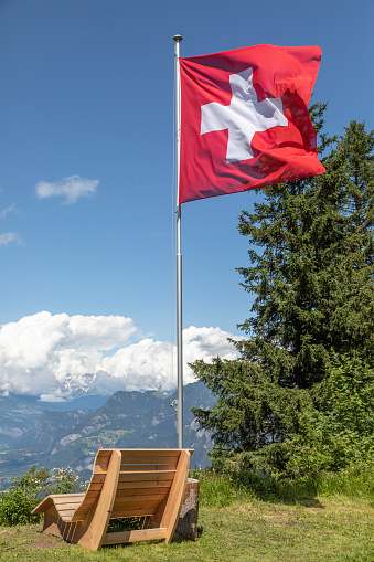 viewpoint with wooden bench on chur's local mountain