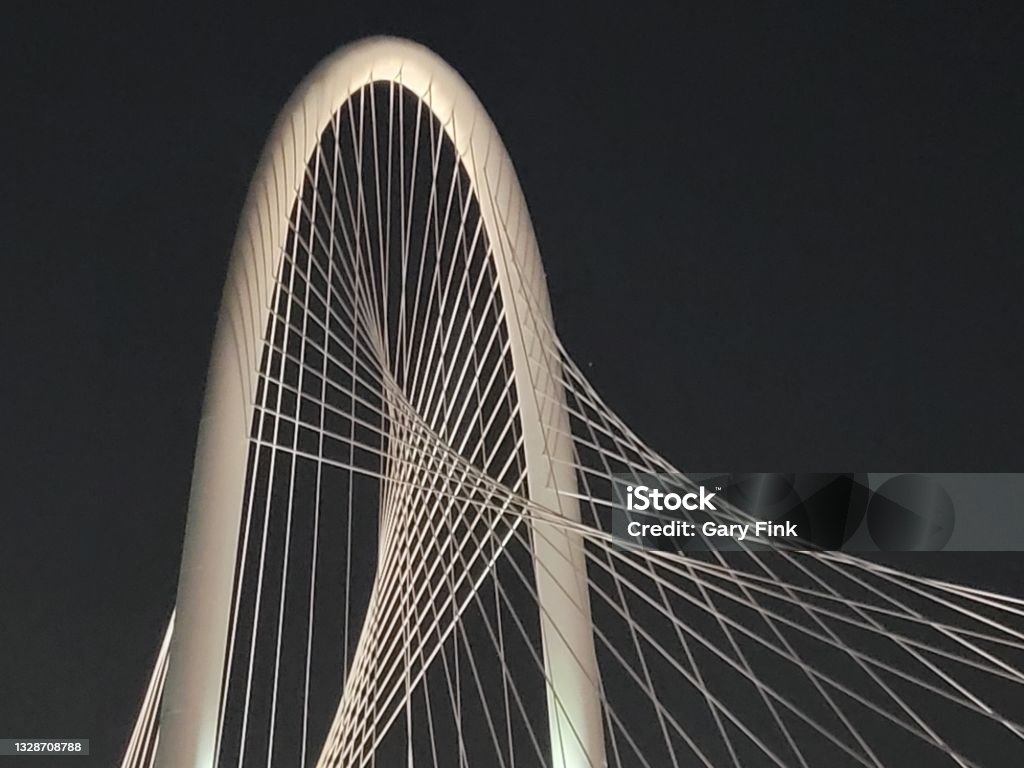 Views of Dallas from Margaret Hunt. Beautiful Arch Suspension Bridge Dallas Texas and Bridge at Night ovr the Trinity River. Bridge - Built Structure Stock Photo