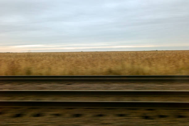Riding parallel to railroad tracks on a passenger train in the country in Mendota, IL, United States