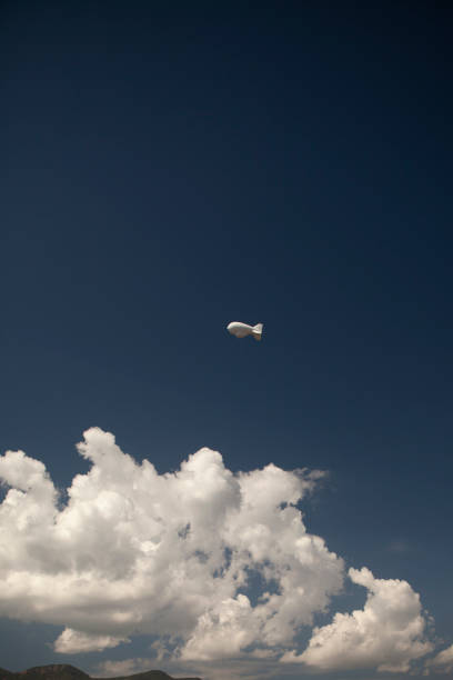 A weather balloon floats above the clouds in a view looking up A weather balloon floats above the clouds in a view looking up in Sierra Vista, AZ, United States weather balloon stock pictures, royalty-free photos & images