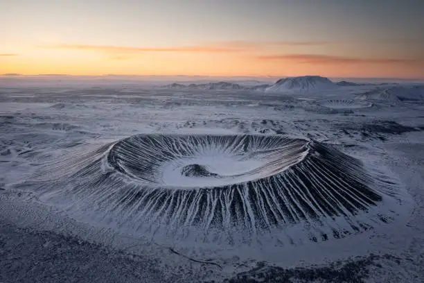 Photo of Hverfjall volcano crater from aerial view at sunrise