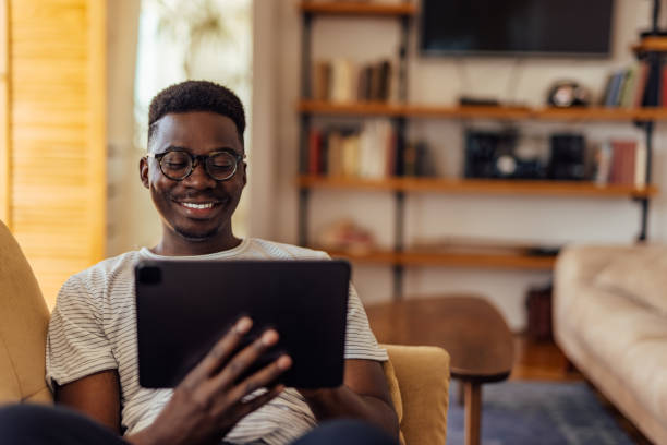 istock African man, relaxing at home, alone. 1328712073