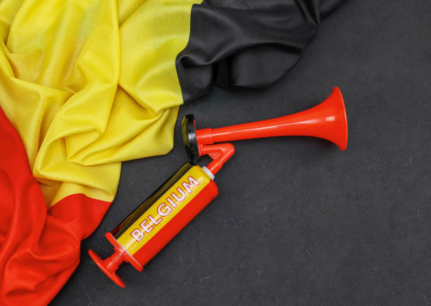 Belgian flag and fan trompe on black background.