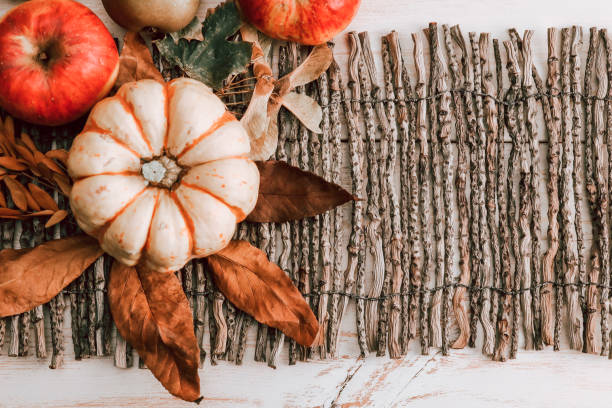 istock Pumpkin with apples and leaves on a wooden table. 1328712367