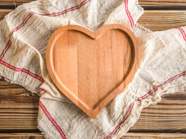 istock Heart shaped plate with kitchen napkin on the table. 1328713083