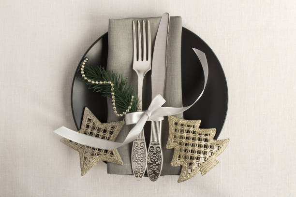 christmas table setting on the black plate on  the on the white textile background. top view. copy space. - napkin black blank ideas imagens e fotografias de stock