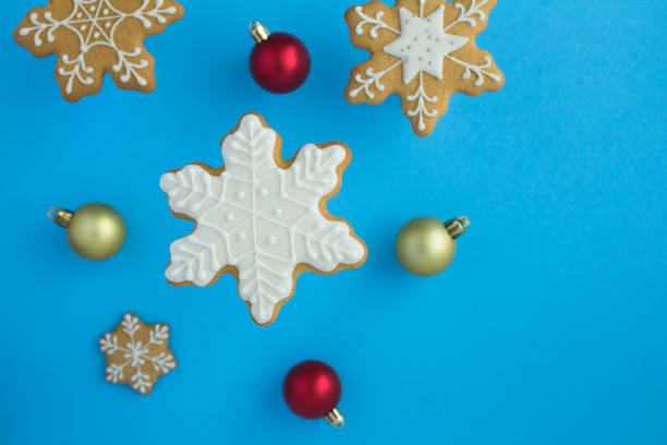 istock Christmas snowflakes-shaped gingerbreads on the blue background 1328715580