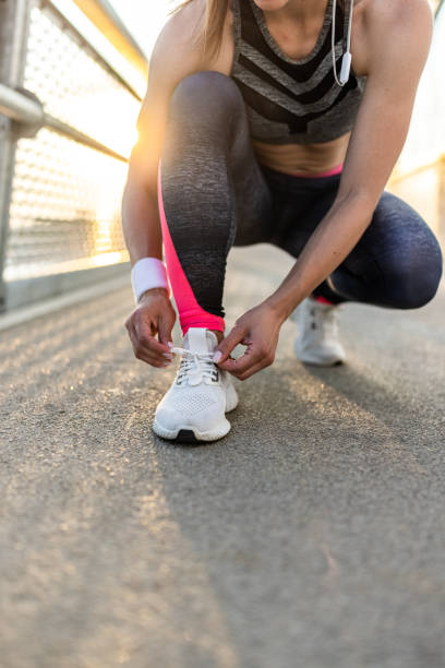istock Woman tying her sport shoe 1328719402
