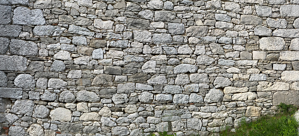 Frontal picture of a limestone wall in a mediterranean village - stock photo