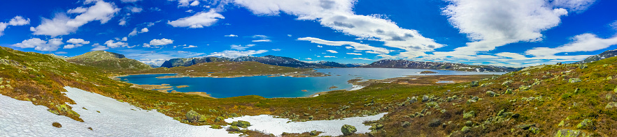 Amazing Vavatn lake panorama rough landscape view rocks boulders and mountains during summer in Hemsedal Norway.