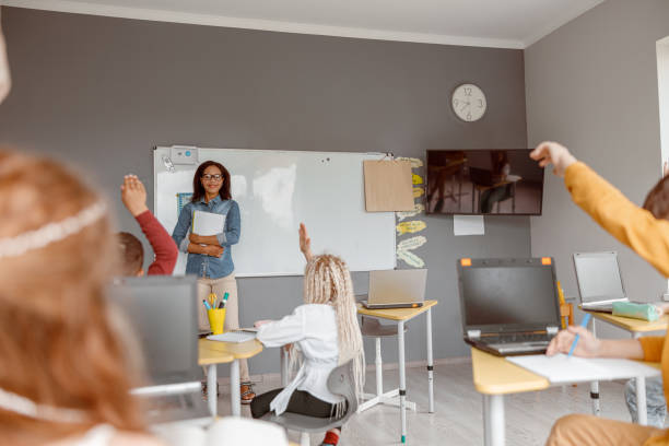 istock School children sitting in classroom at lesson 1328727326