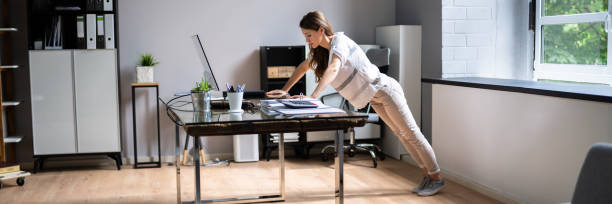 istock Side View Of A Young Businesswoman Doing Push Up 1328727558
