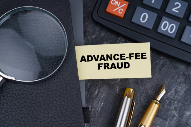 istock On the table is a calculator, a pen and a notebook with a bookmark on which it is written - ADVANCE-FEE FRAUD 1328728203