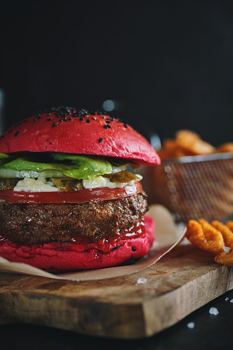 Red Bun Beef Burger with Tomato, Cheese, Avocado, Pickles Served with Chip Fries