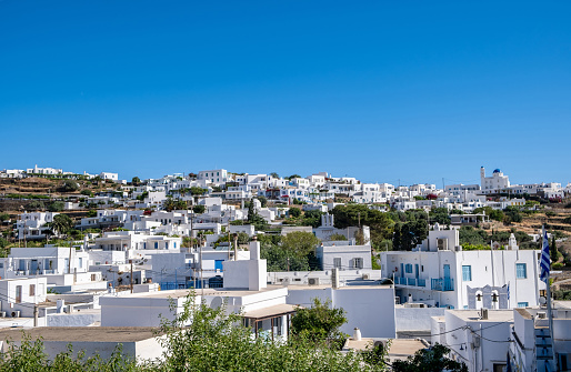Greece. Sifnos island, Artemonas town, view from Apollonia Chora village. Cyclades traditional architecture, whitewashed buildings uphill, blue sky background. Summer holidays destination