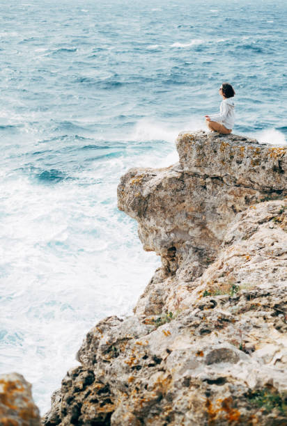 istock Woman meditating by the sea. 1328729926