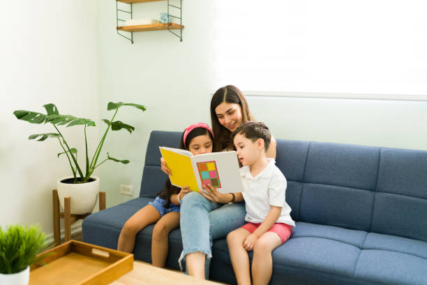 istock Beautiful mom teaching her children how to read 1328730309