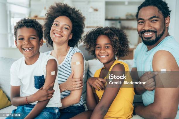 Portrait Of A Vaccinated Family Stock Photo - Download Image Now - Vaccination, Cold And Flu, Child
