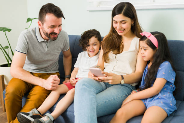 istock Beautiful mom texting with her cheerful family 1328730745