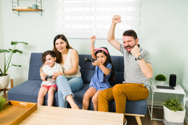 istock Father and daughter winning a video game match 1328731305