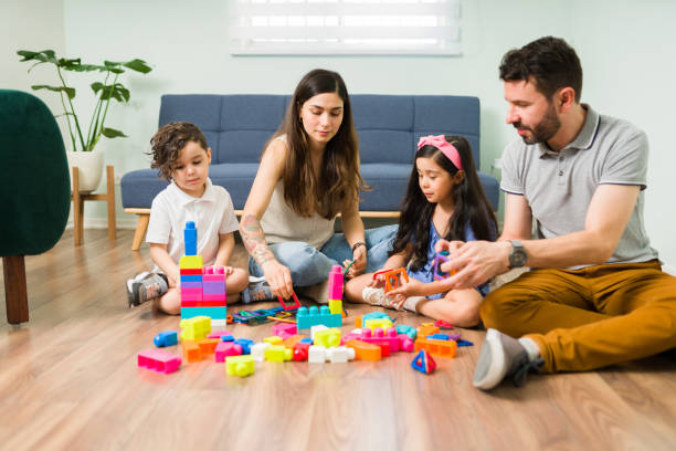 istock Mom and dad enjoying a game with their children 1328731476