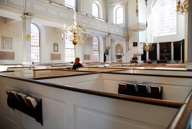 Old North Church Interior Boston, MA, USA February 5 A young woman sits solemnly n a booth of the Old North Church in Boston north end boston photos stock pictures, royalty-free photos & images
