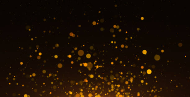 istock Golden Defocused Particles against Black Background 1328733268