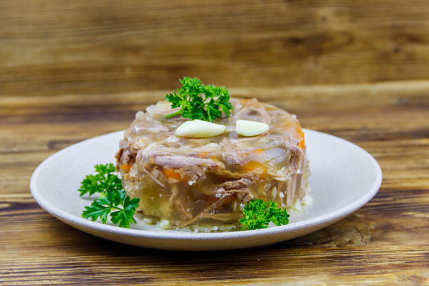 Meat aspic in a plate on a wooden table. Traditional russian dish Meat aspic in a plate on a wooden table. Traditional russian dish aspic stock pictures, royalty-free photos & images