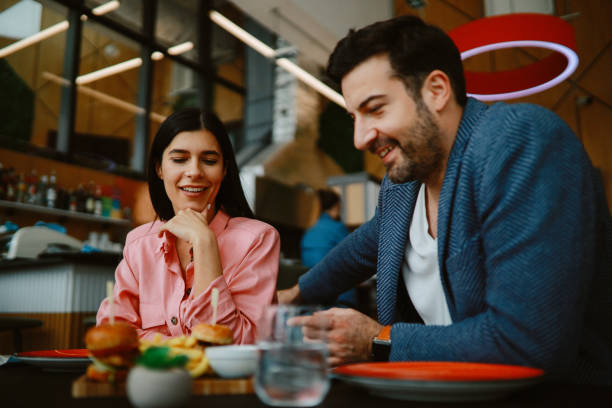 istock Young couple in the burger restaurant 1328735769