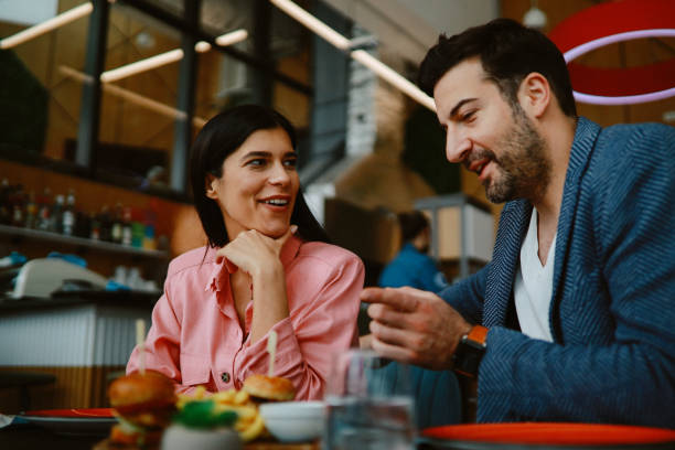 istock Young couple in the burger restaurant 1328735875