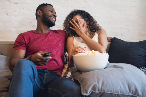 istock Young couple watching a horror movie at home. 1328739364