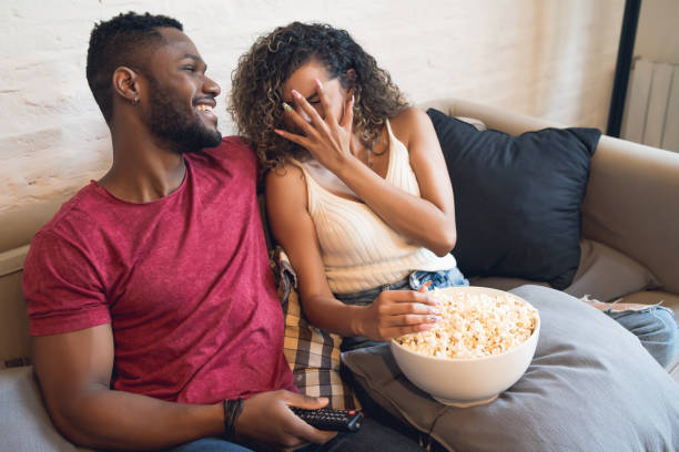 istock Young couple watching a horror movie at home. 1328739384