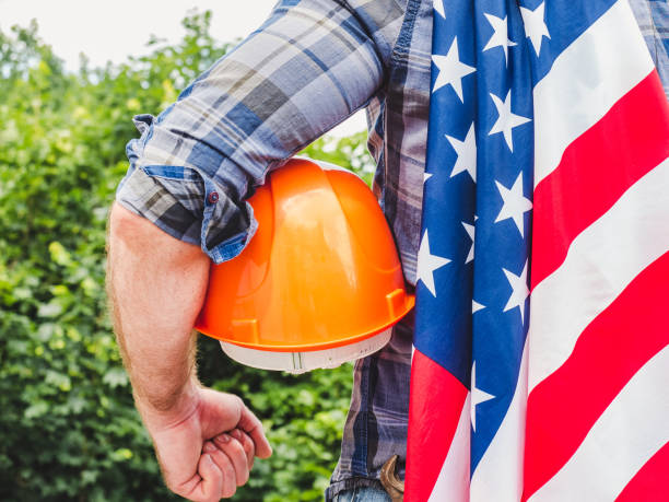 istock Handsome man holding US Flag. Labor and employment concept 1328740446