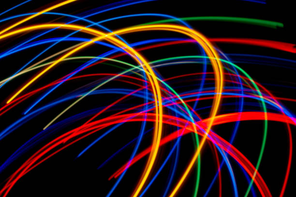 istock colored lines of lights on a black background 1328744345
