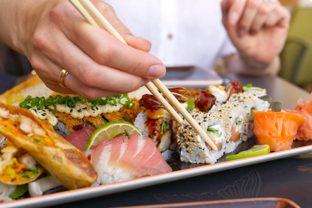 istock eating sushi with chopsticks at sushi restaurant 1328745291