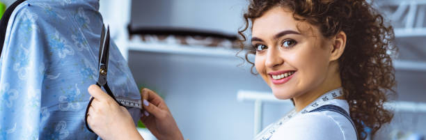istock The beautiful tailor working with the dress 1328748597