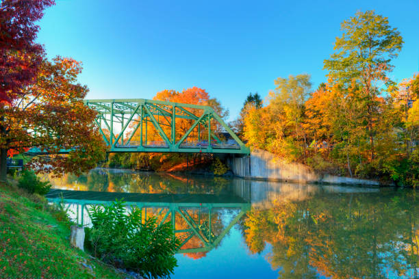 Bridge and beautiful fall leaves on the Erie Canal-Pittsford, NY Bridge and beautiful fall leaves on the Erie Canal-Pittsford, NY erie canal stock pictures, royalty-free photos & images