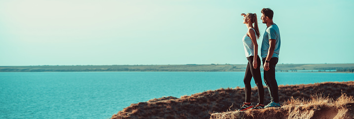 The young couple enjoy the time near the sea