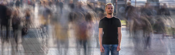 The man stands on the crowded street