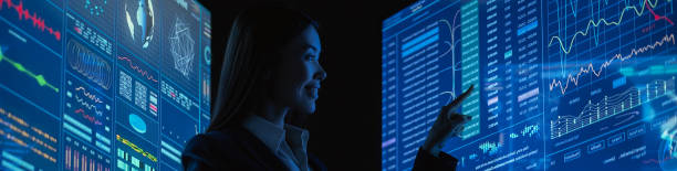 istock The business lady standing between blue monitors in the dark office 1328750961