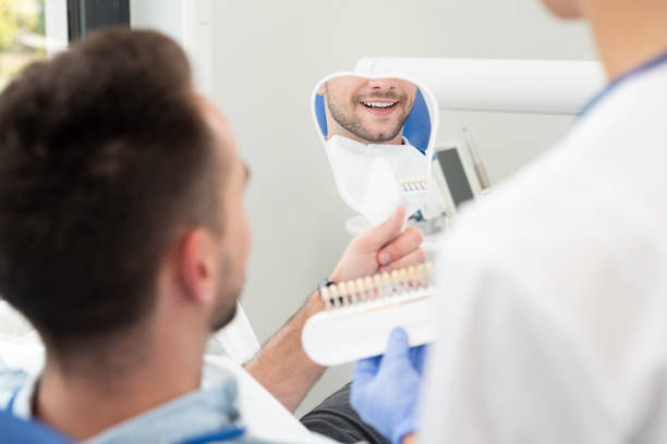 istock Man in stomatology clinic. Teeth whitening. 1328753534