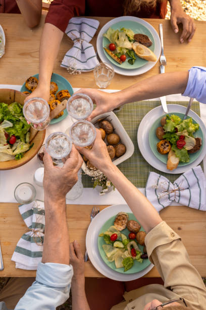 istock Family Members Clinking Glasses 1328754590