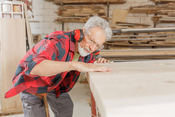 istock A Skillful and Experienced Carpenter is Working in the Carpentry Workshop Using Sand Paper. 1328759184