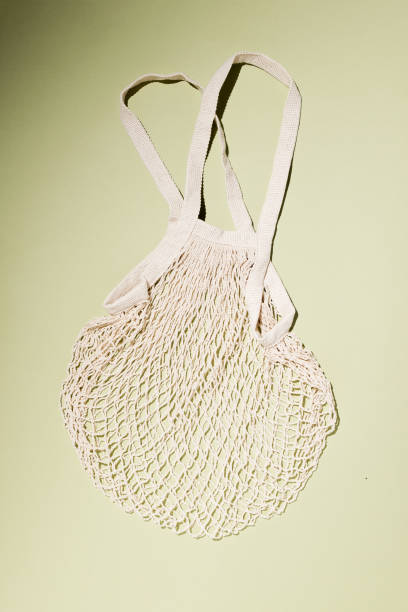 istock Reusable cotton shopping string bag on green background. Zero waste concept. No plastic 1328761084