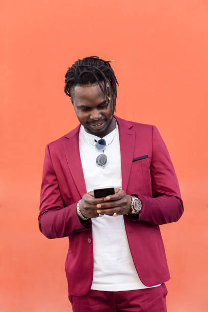 istock stylish african man typing message on smart phone 1328765280