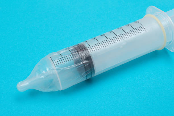 istock Anti Vaccination Concept - Syringe in a Condom 1328769392
