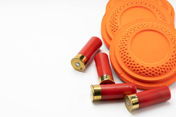 istock Clay disc flying targets and shotgun bullets on white background ,Clay Pigeon target 1328774085