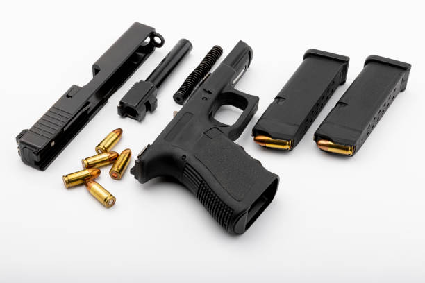 Parts of automatic pistol handgun with magazine on white isolated background Parts of automatic pistol handgun with magazine on white isolated background gunman photos stock pictures, royalty-free photos & images