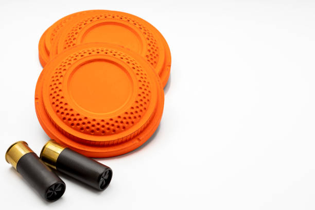 istock Clay disc flying targets and shotgun bullets on white background ,Clay Pigeon target 1328776747