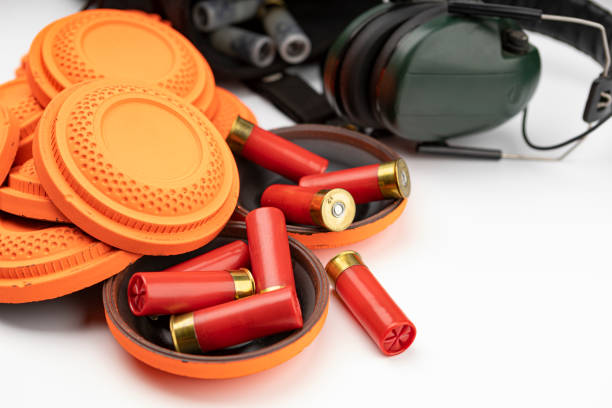 istock Shotgun bullets and Clay disc flying target on white background 1328776755